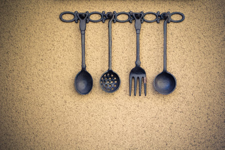 Set of kitchen utensils hanging on the wallの写真素材
