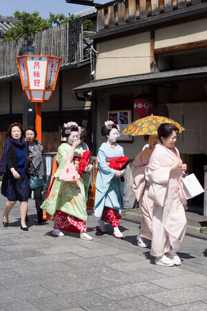 KYOTO, JAPAN - April 15  Traditional geishas are walking pass on Gion street in Kyoto on April 15, 2014 in Kyoto, JAPAN  There are about 2,000 geishas in Japan today, preserving ancient arts and customs in modern life のeditorial素材