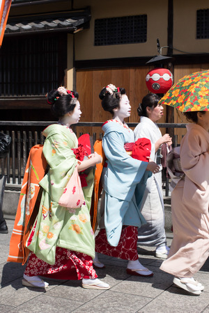 KYOTO, JAPAN - April 15  Traditional geishas are walking pass on Gion street in Kyoto on April 15, 2014 in Kyoto, JAPAN  There are about 2,000 geishas in Japan today, preserving ancient arts and customs in modern life のeditorial素材