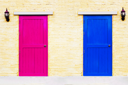 A vintage two tones of couple doors on brick wall の写真素材