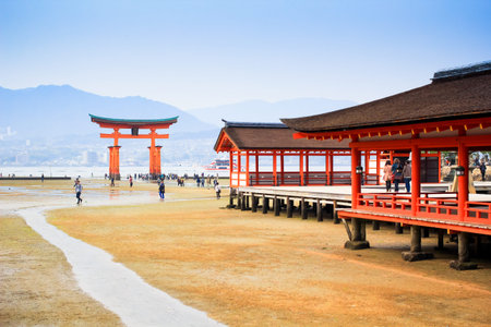 MIYAJIMA, JAPAN - April 16: Giant Torii during low tide near Itsukushima shinto shrine in Miyajima,...