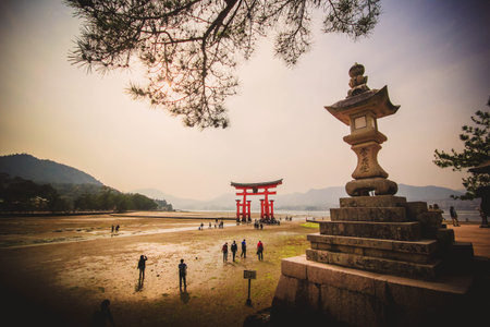 MIYAJIMA, JAPAN - April 16: Giant Torii during low tide near Itsukushima shinto shrine in Miyajima,...