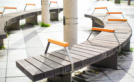 Curved wooden bench in a park for relaxingの写真素材