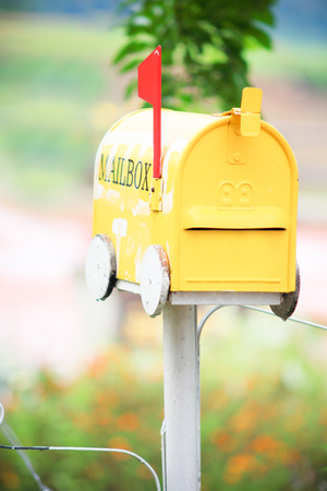Yellow mailbox in gardenの写真素材