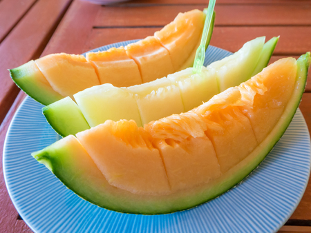 Slice of Japanese melon on dish. Eating for fresheningの写真素材