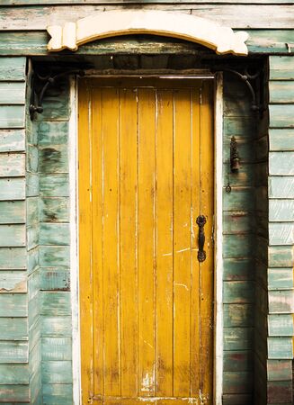 Grunge vintage yellow wooden doorの写真素材