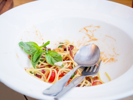 Dirty dish of spicy spaghetti after eattenの写真素材