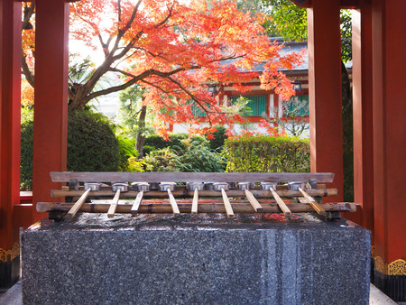 Holy water well in front of the Yutoku Inari Shrine with color change of autumn leave in Saga prefecture, Japanのeditorial素材