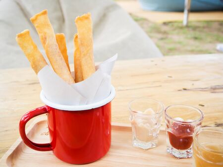 Crispy spring roll stick in a red cupの写真素材