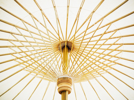 Thai Orient paper umbrella with bamboo stalksの写真素材
