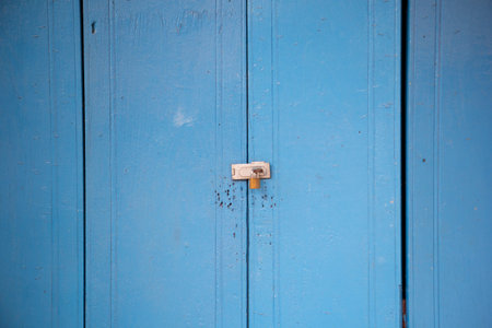 A key lock on a wooden blue doorの写真素材