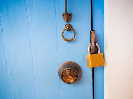 A key lock on a wooden blue door