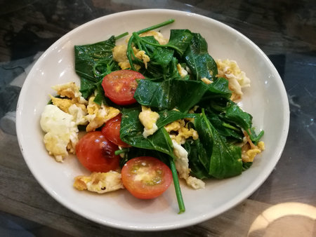 Close-up healthy stir-fry vegetable with tomato and egg for diet and detox to clean your body and...