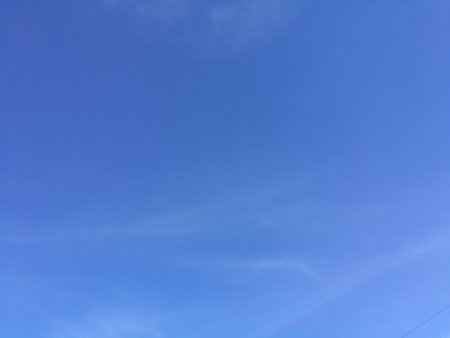 Clear blue sky with soft white clouds, Beautiful blue sky with little fluffy clouds in a shiny summer dayの写真素材