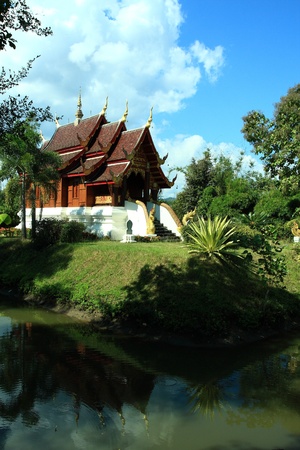 New development temple wat padad behind lakeの写真素材