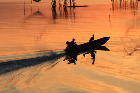 Boat fishermen are fishing in the morningの写真素材