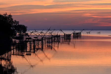 Sunrise with fishing tools rim seaの写真素材
