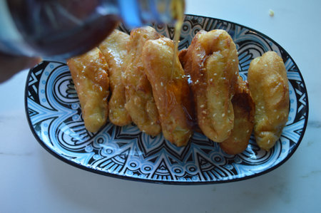 Deep-fried dough stick with sweet and sour sauce on the plate