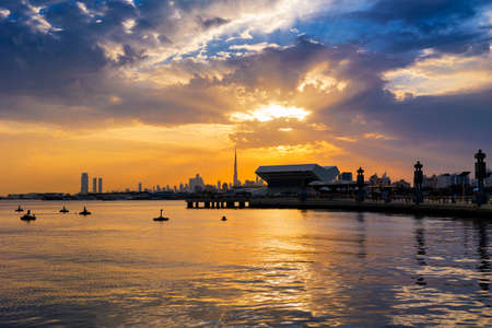 Beautiful view of Dubai Skyline in the evening. Dubai city during golden hour or sunset with a beautiful cloudy sky with a nice reflection on the water.の写真素材