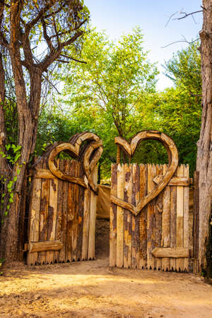Wooden heart or love shaped symbol. Entangled Love, two wooden shaped love symbols twisted together. Love lake Dubai.の写真素材