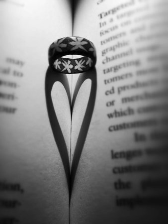Heart shadow from ring on the bookの素材