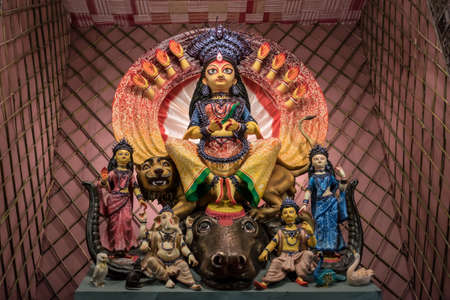 Goddess Durga idol at decorated Durga Puja pandal, shot at colored light, at Kolkata, West Bengal, India. Durga Puja is biggest religious festival of Hinduism and is now celebrated worldwide.の写真素材