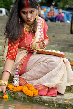 Portrait of beautiful Indian girl wearing traditional Indian saree, gold jewellery and bangles...