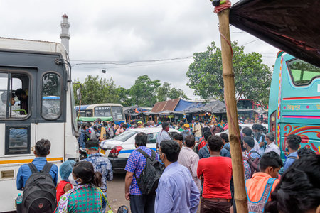 People gathered in the bus stand waiting for the bus with masks during unlock period in Kolkata,...