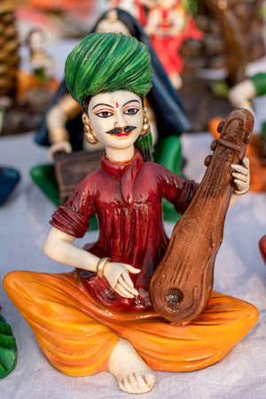 Beautiful handmade dolls of miniature folk musicians performing in a band of classical Indian music is displayed in a shop for sale. Indian handicraft.の写真素材