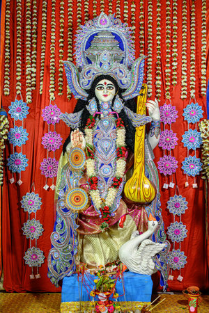 Idol of Goddess Devi Saraswati at a decorated puja pandal in Kolkata, West Bengal, India on February 14, 2024. Saraswati Puja is a popular religious festival of Hinduism.のeditorial素材