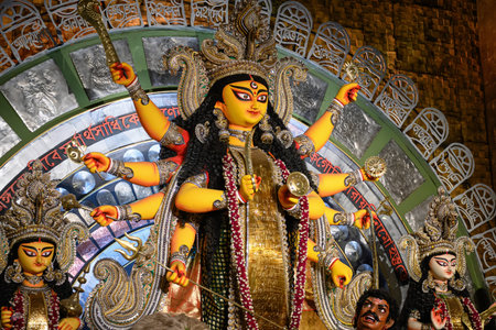 Idol of Goddess Devi Durga at a decorated puja pandal in Kolkata, West Bengal, India on October 21, 2023. Durga Puja is a religious festival of Hinduism that is celebrated across the globe.のeditorial素材