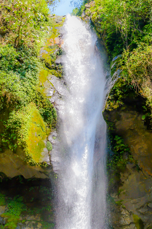 A close up view of cascading water falling over the rocks from top.の写真素材