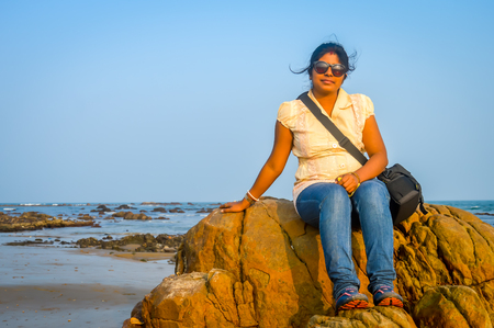 Cute woman relaxing on the tropical beach, outside tropical resort, Vacation concept. Goa Indiaの写真素材