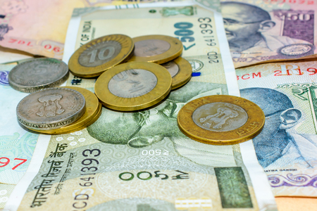 Piles of currency Indian Rupees in notes and coins in different denominations. Save money for the future. d old coins. Saving money and account finance bank business concept.の写真素材