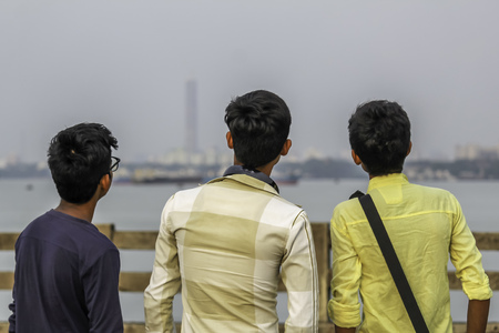 Group of three friends having fun at sunset time. Happy friendship day advertising concept. Space for textの写真素材