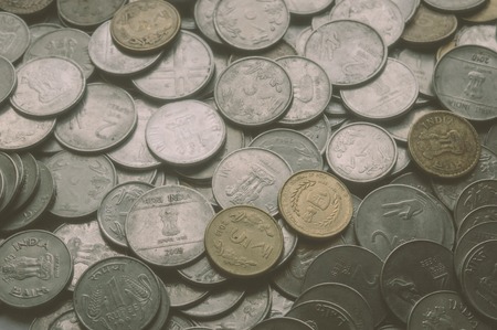 Stock pile of Hundred number 1, 10, 5 Indian rupee metal coin currency on isolated background. Financial, economy, investment concept. Banking and exchange object. closeup. Vintage tone filter effect.の写真素材