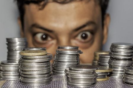 Focus on Coin. A rich greedy elderly man looks at coins. The collector looks at his wealth. An...