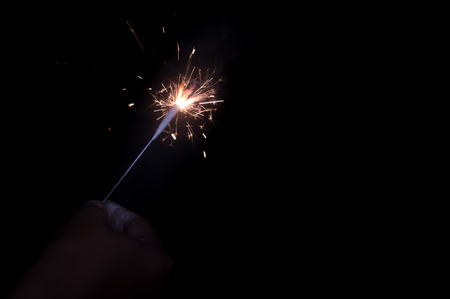 Selective focus. Fireworks Holiday firework in night Firecracker sparks. Happy new year decoration isolated. Explosion firecracker, holiday celebration. Christmas sparklers, isolated black backgroundの写真素材