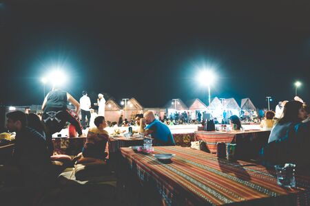 North Goa, India - January 2, 2019: Customers dining at a famous coastal cafes in the late night party. It outdoor restaurant cafe or a traditional hippie bar at shore of tropical island in open air.のeditorial素材