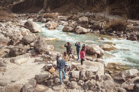 Teesta River front, Yumthang Valley, January 1 2019: Tourist people taking selfie too close to River after a recent news that group of teenager have drowned in river for photography amusement purposesのeditorial素材
