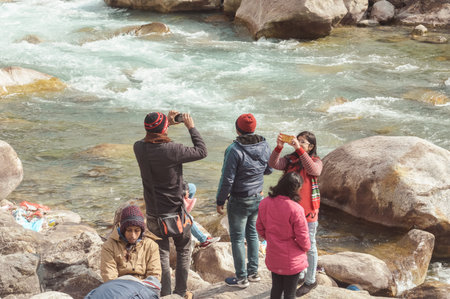 Teesta River front, Yumthang Valley, January 1 2019: Tourist people taking selfie too close to River...