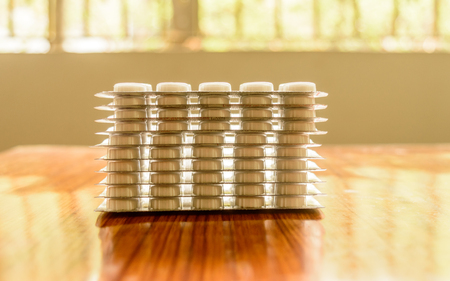 Heap of Capsules packed in blisters, round patterned shaped medicine tablet or antibiotic pills. Medical Pharmacy theme. Close up with copy space.の写真素材