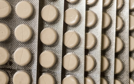 Heap of Capsules packed in blisters, round patterned shaped medicine tablet or antibiotic pills. Medical Pharmacy theme. Close up with copy space.の写真素材