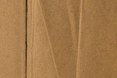 Surface of cut and torn sheet brown color old and vintage cardboard paper box. Abstract texture background close up. Natural canvas pattern background. Studio shot with copy space room for text.の写真素材