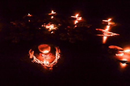 Group of decorated Diya- Oil Lamp lit in festival season of Diwali on black background. Concept of removing darkness.の写真素材