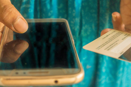 Out of focus Asian and Indian woman paying bill at home with online payment technology via internet,...