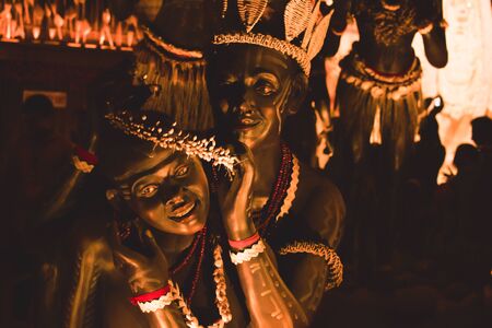 KOLKATA , INDIA SEPTEMBER 26, 2017 - Decorated art and craft sculptures of Traditional tribal Santal or Santhal ethnic group dancers making love wear traditional clothing in famous Durga Puja pandal.のeditorial素材