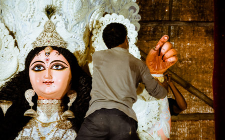 Kolkata, West Bengal, India, September 2018 - The artisan or God Makers of Kumortuli, work on giving...