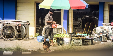 Kolkata India May 2018 - A man with plastic shopping bag walking down the city street despite called for ban on single use carryout bags at stores on environment day to end plastic pollution in World.のeditorial素材