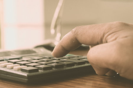 Close up of Press the right button. Calculator with finger. Fingers pressing the buttons of...